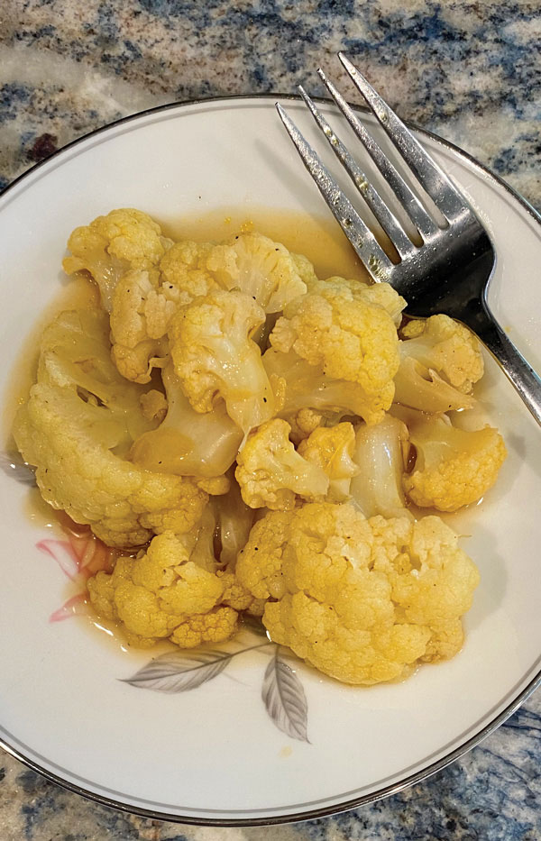 Cauliflower Simmered in Broth shown on serving plate.