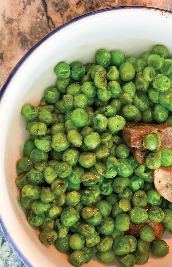 Sauteed Sweet Peas & Mushrooms shown in a serving bowl.