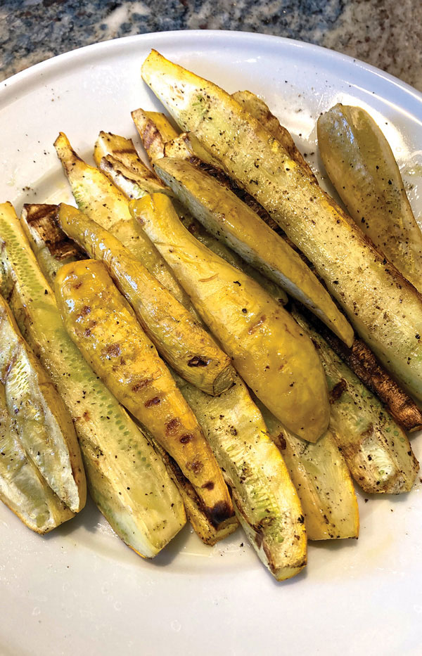 Charcoal Grilled Yellow Squash shown on a serving plate.
